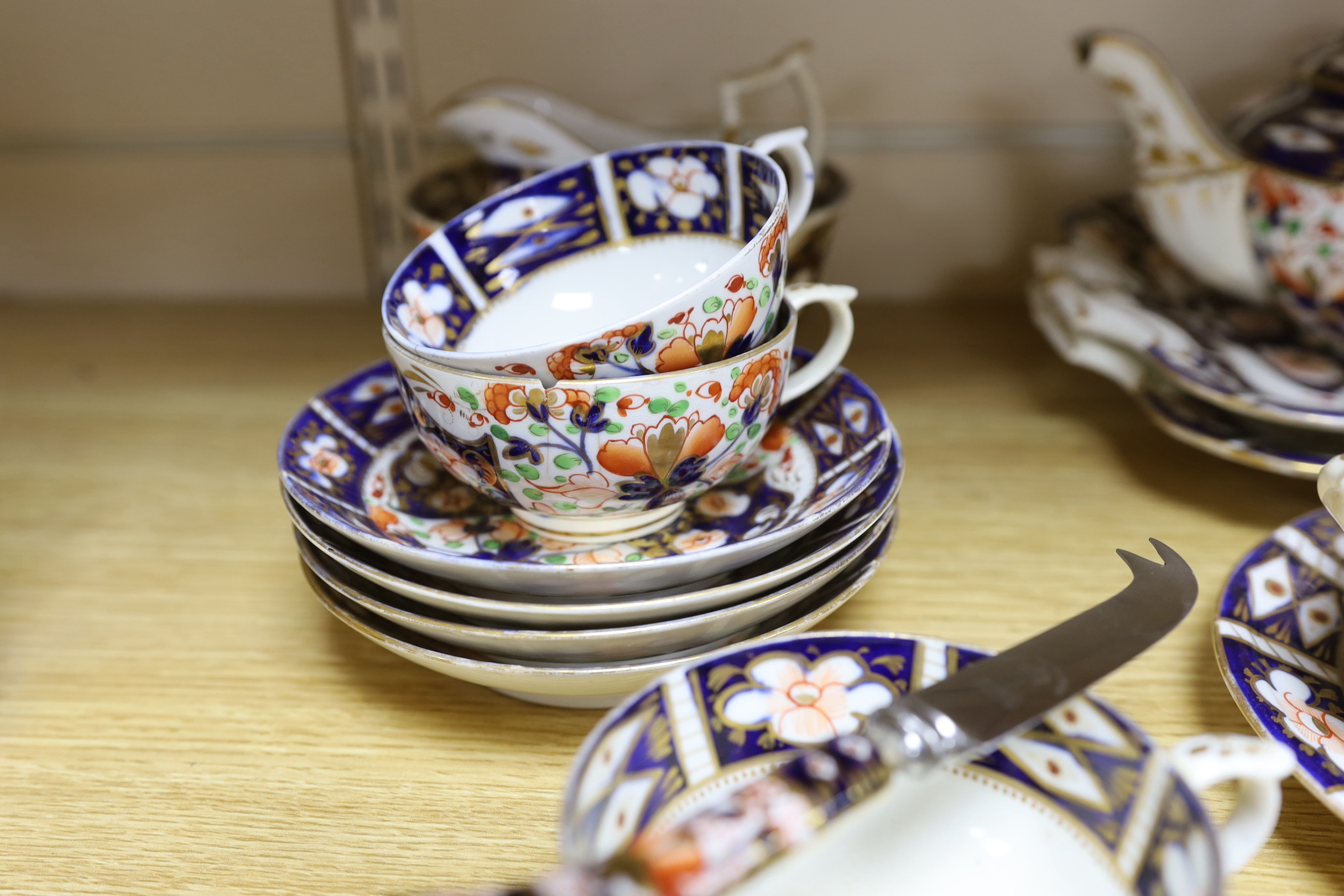 A mid 19th century Derby Imari pattern tea service, comprising a pair of two handled cake plates, a teapot on stand, a sucrier, a cream jug, a bowl and cover, three cups and four saucers, NB: From the Estate of Rt Hon Lo